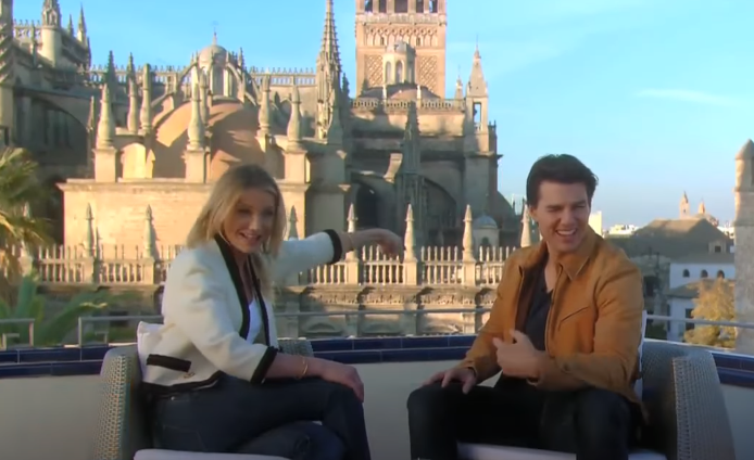 Tom Cruise & Cameron Diaz sitting down on a rooftop terrace with the Cathedral proudly showing in the background