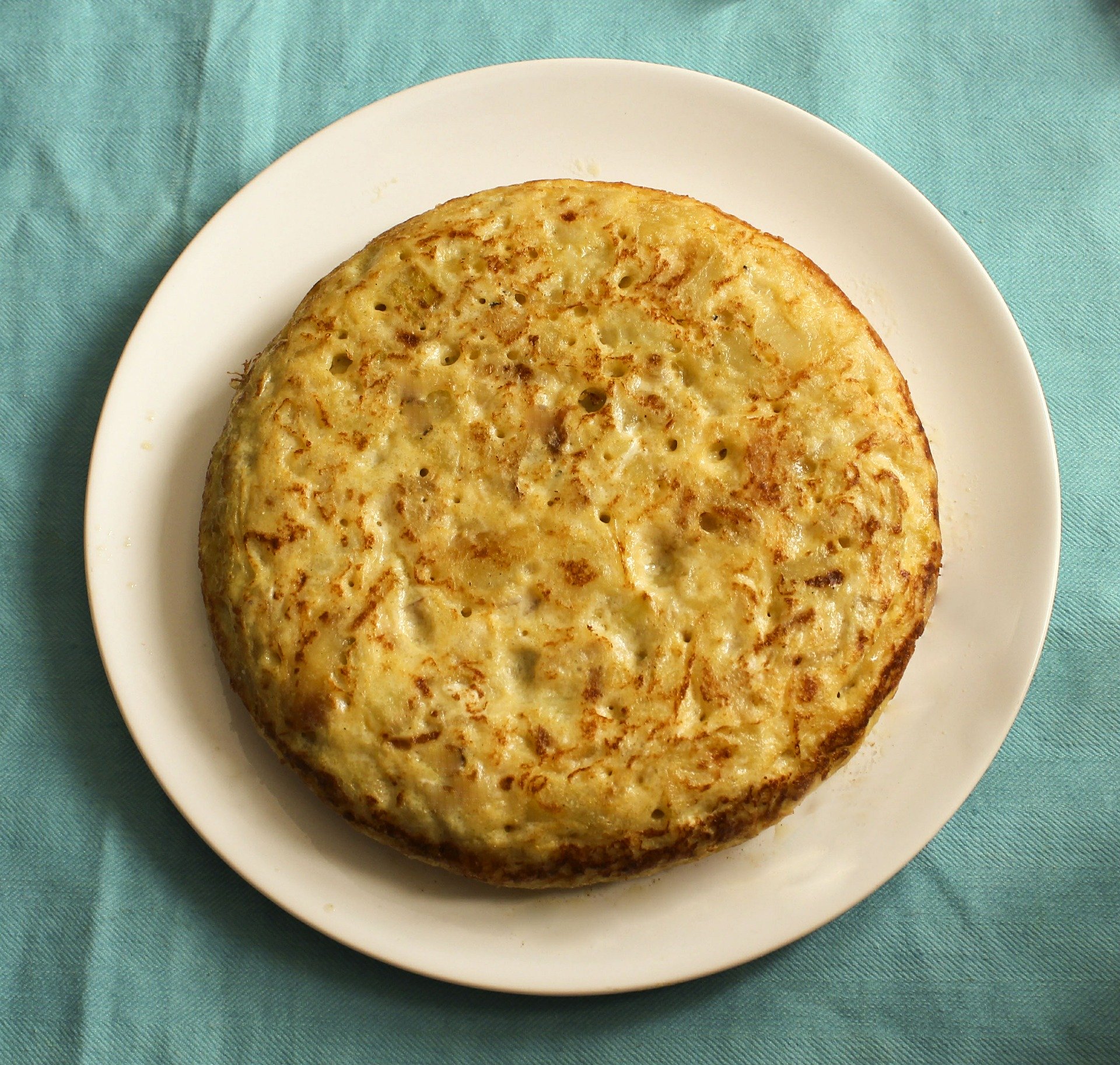 A cooked potato tortilla served on a plate